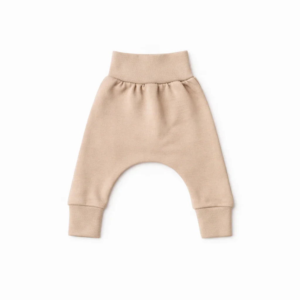 Beige baby harem pants with elastic waist and cuffs, soft knitwear for comfortable everyday wear