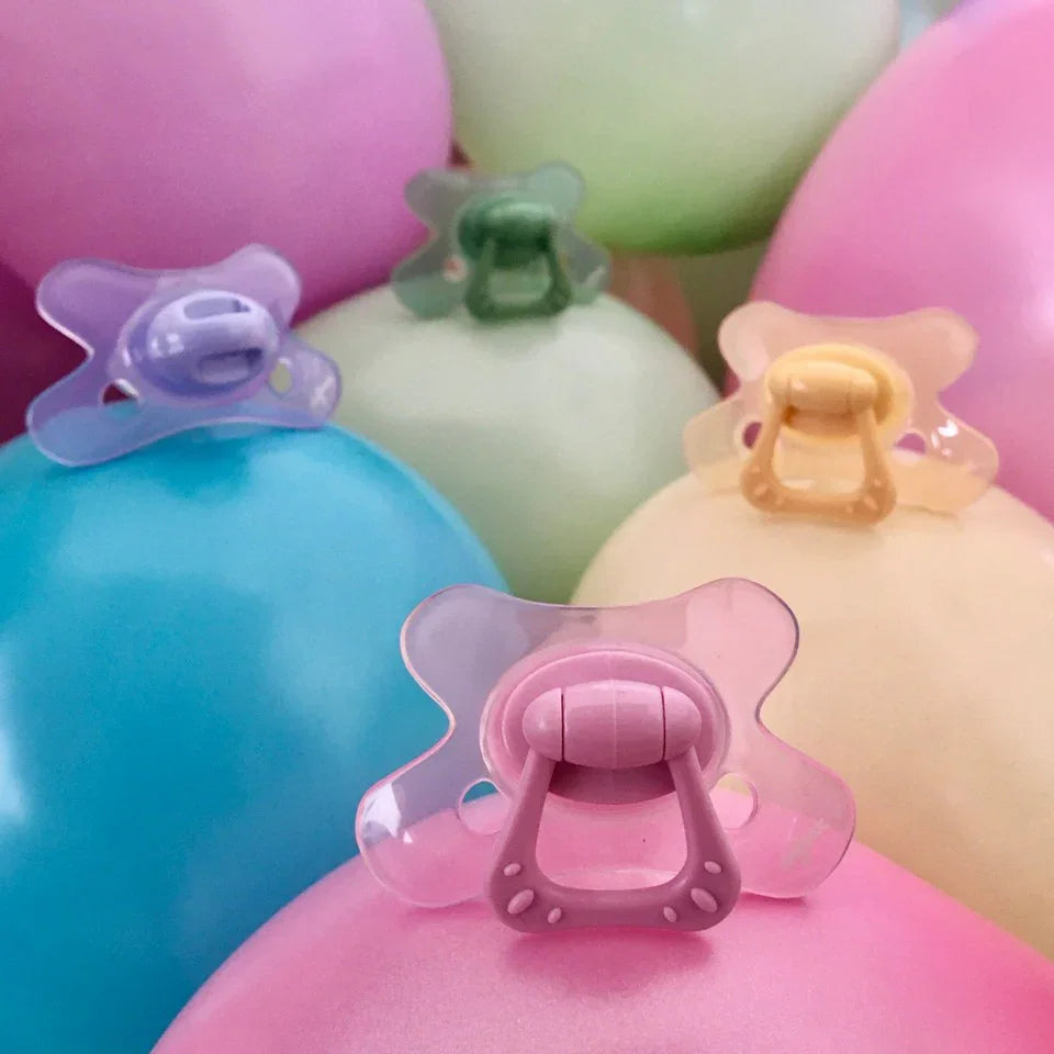 Colorful baby pacifiers on pastel balloons, perfect for baby showers and newborn essentials