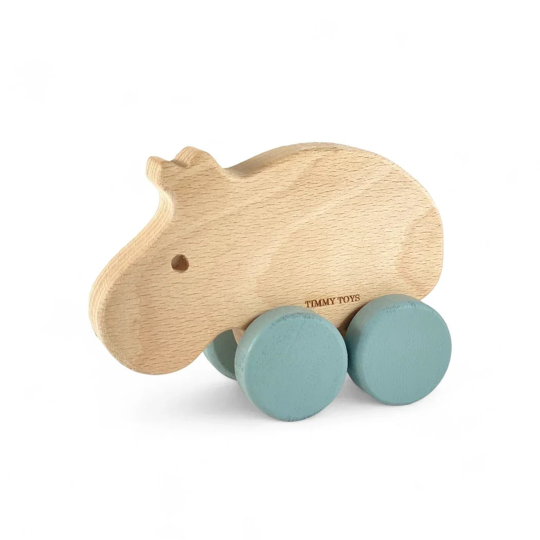 Natural wood hippo push toy with teal wheels, ideal for baby and toddler play