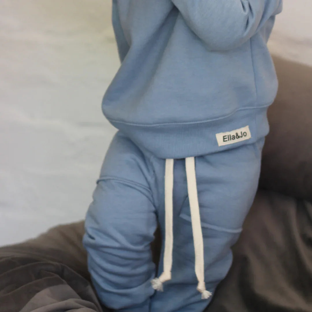 Soft blue baby tracksuit with white drawstrings, cozy knitwear for little ones
