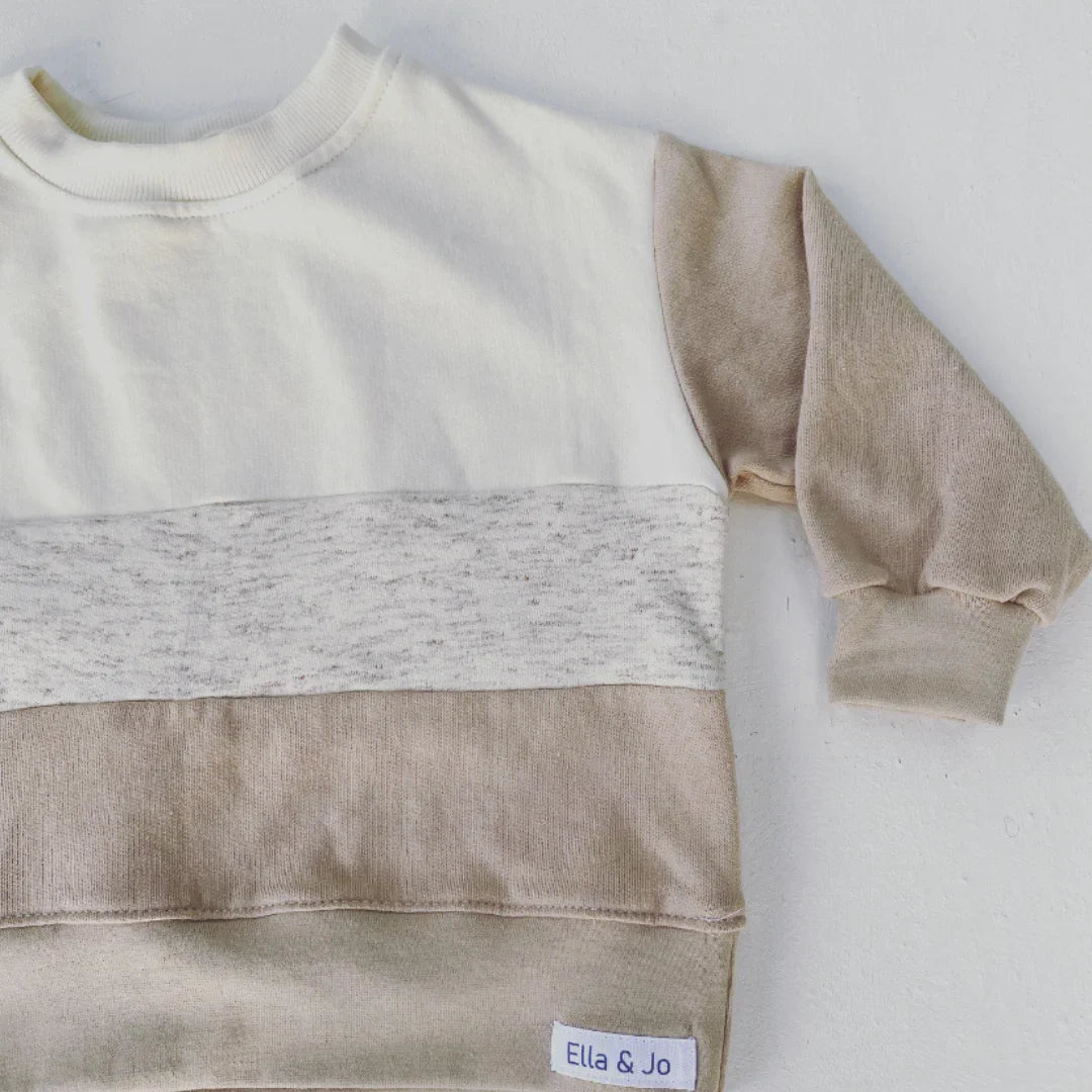 Soft kids' color-block sweater with cream, grey, and beige stripes, cozy knitwear for everyday wear