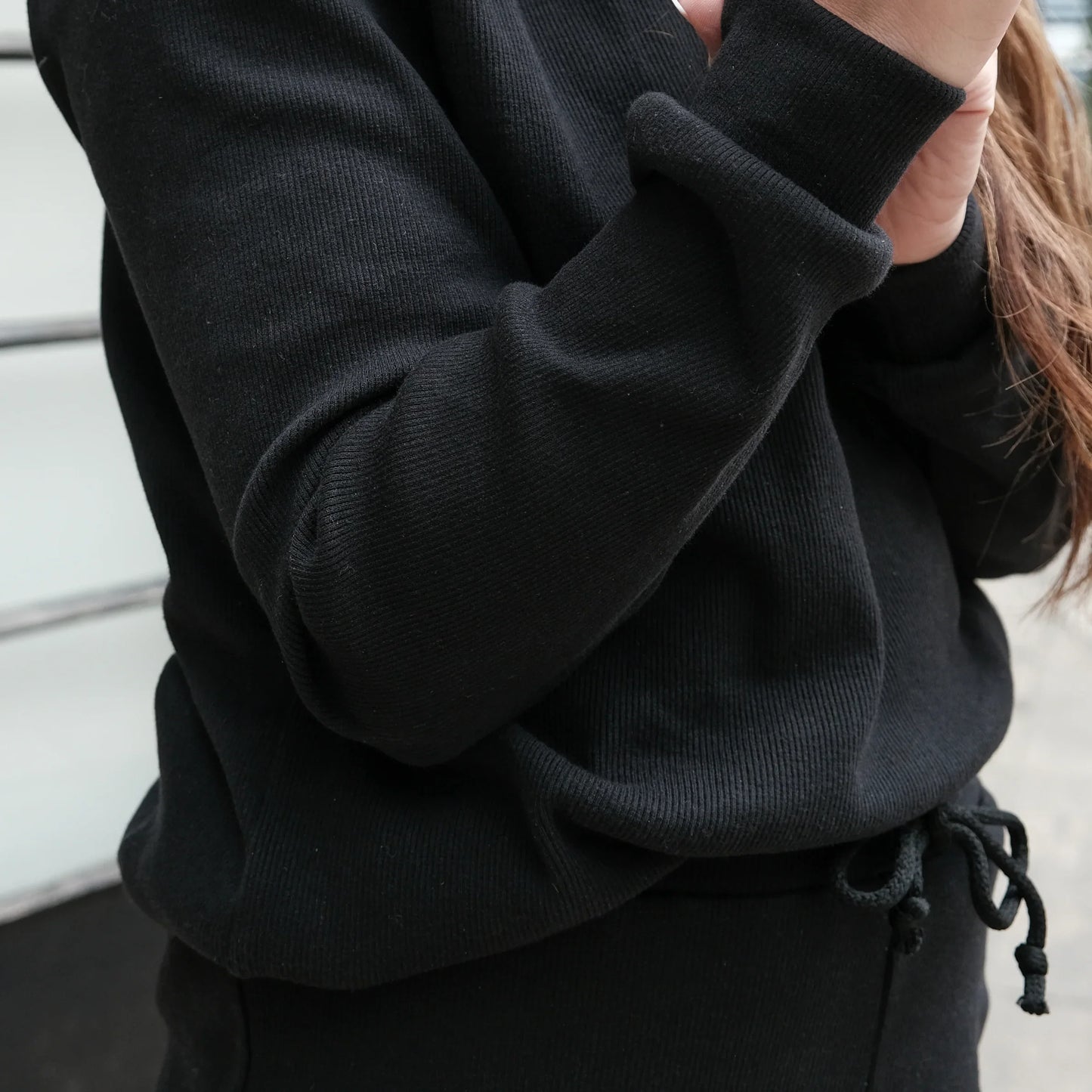 Black ribbed hoodie with drawstring waist, cozy everyday wear for adults