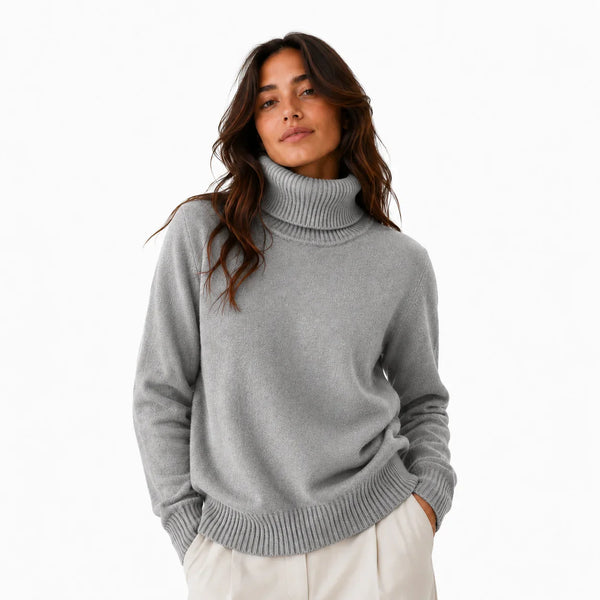 Gray turtleneck sweater with ribbed cuffs and hem, paired with cream pants