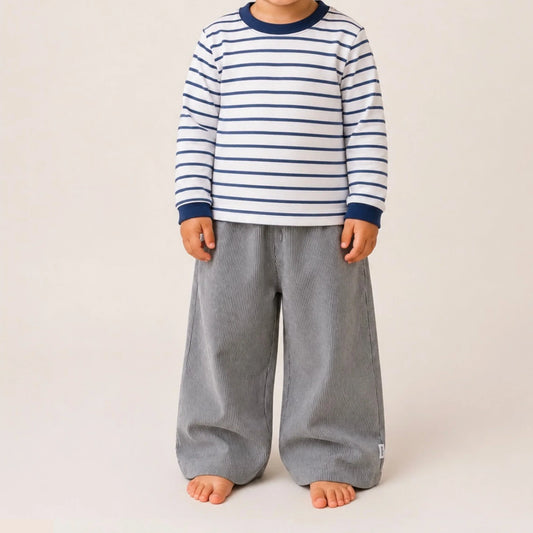 Child wearing striped long sleeve top and grey corduroy pants, South African kids fashion